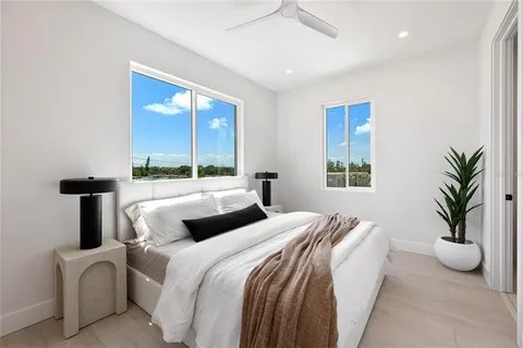 a bedroom with bed and a potted plant