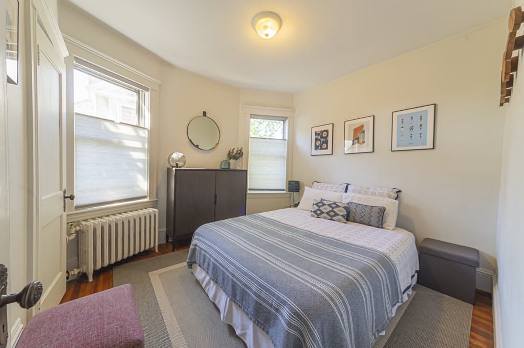 89 Montebello Road, Unit 2 Boston, MA 02130 - Photo 17 of 32 a bedroom with a bed window and a window