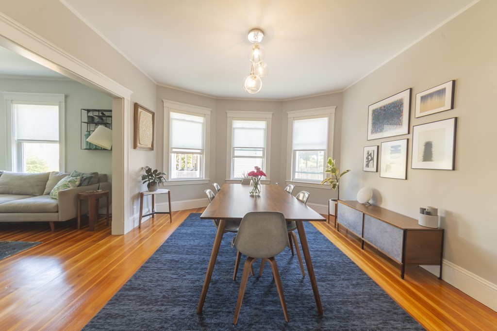 89 Montebello Road, Unit 2 Boston, MA 02130 - Photo 8 of 32 a living room with furniture wooden floor and a table