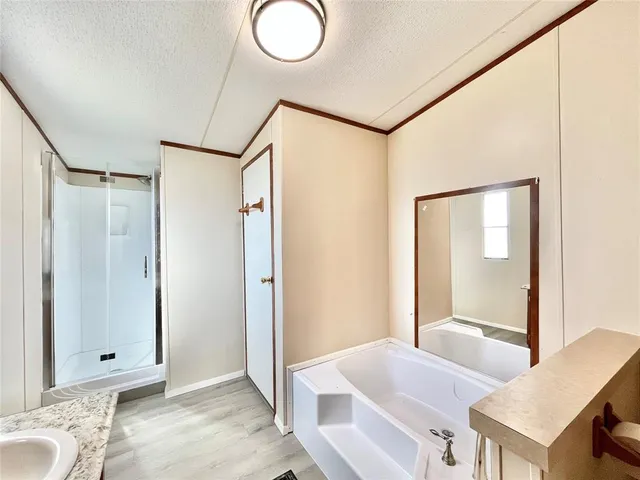 a view of a bathroom with tub and mirror