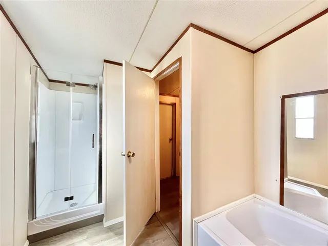 a bathroom with a tub and shower