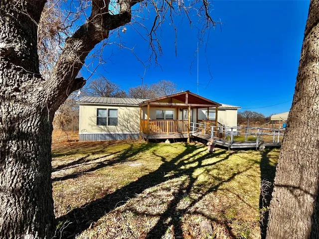 a view of a house with wooden deck