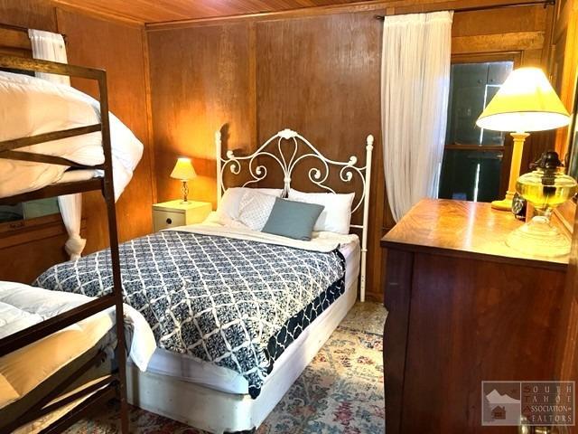 127 46 Milestone South Lake Tahoe, CA 95721 - Photo 17 of 22 a bedroom with a bed and a dresser with wooden floor