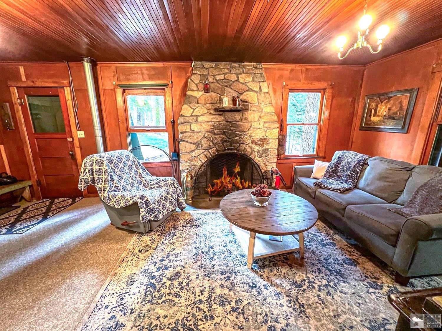127 46 Milestone South Lake Tahoe, CA 95721 - Photo 5 of 22 a living room with furniture a fireplace and a table
