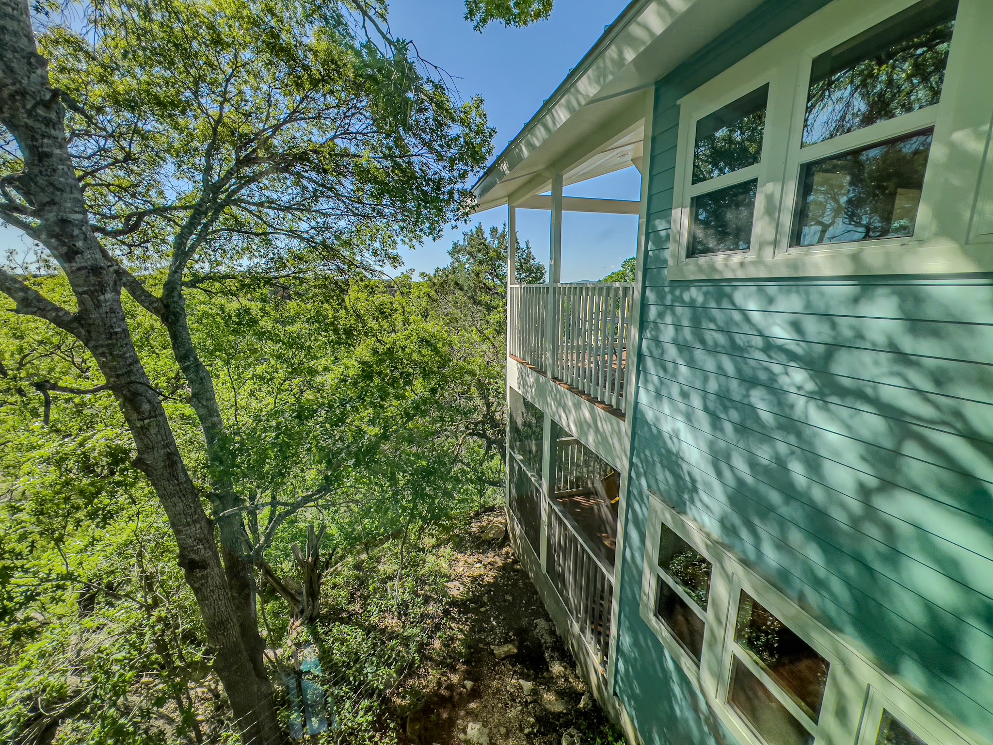 550 Cliffside Road Wimberley, TX 78676 - Photo 33 of 35 a view of a brick house with a tree