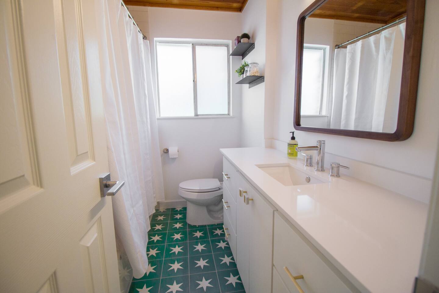 1913 Rabb Road, Unit B Austin, TX 78704 - Photo 6 of 10 Bold patterned tile flooring adds character to this well-appointed bathroom.