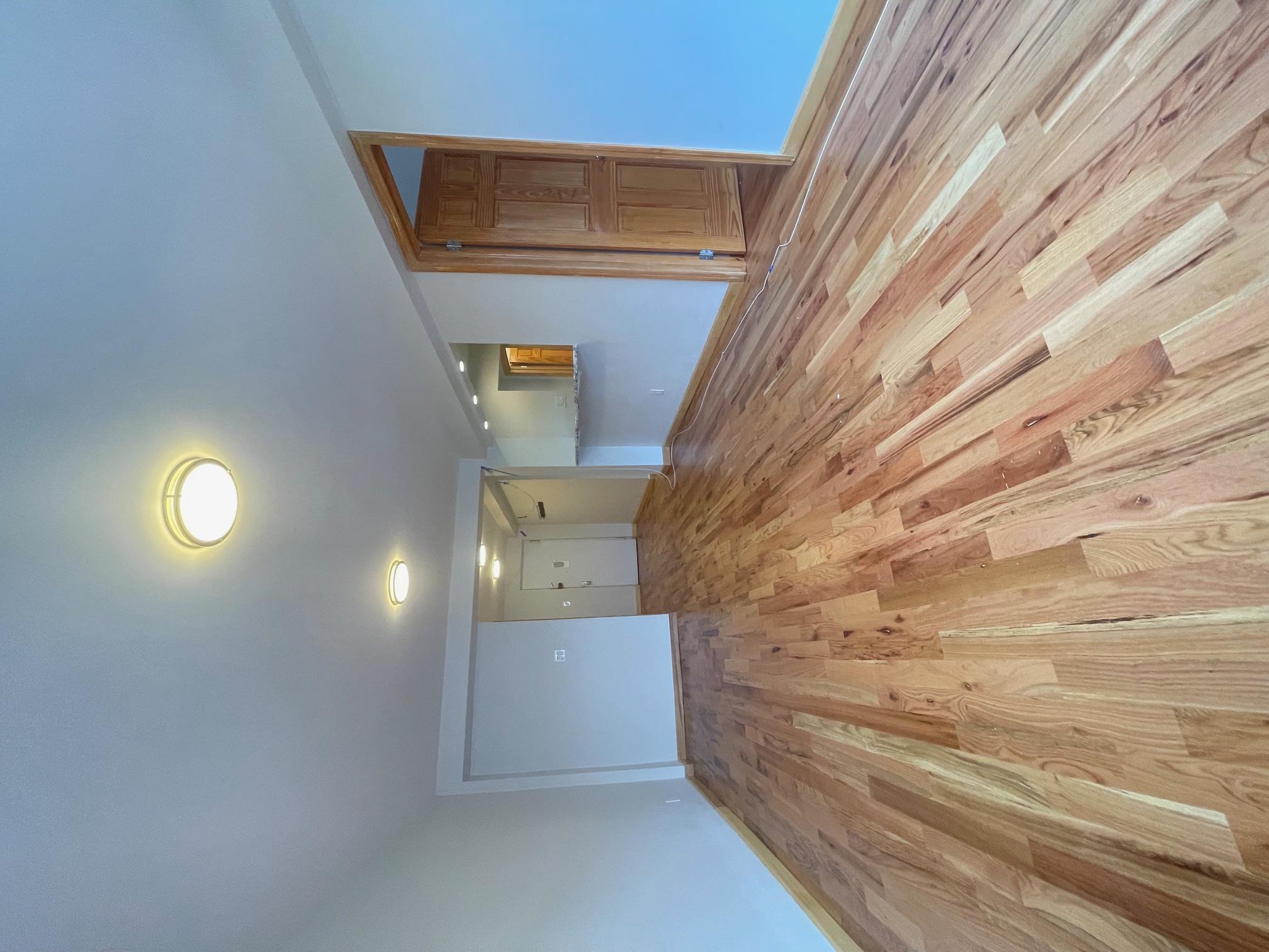 59-30 108th Street, Unit 2JJ Queens, NY 11368 - Photo 11 of 15 Unfurnished living room with light wood-style flooring and baseboards