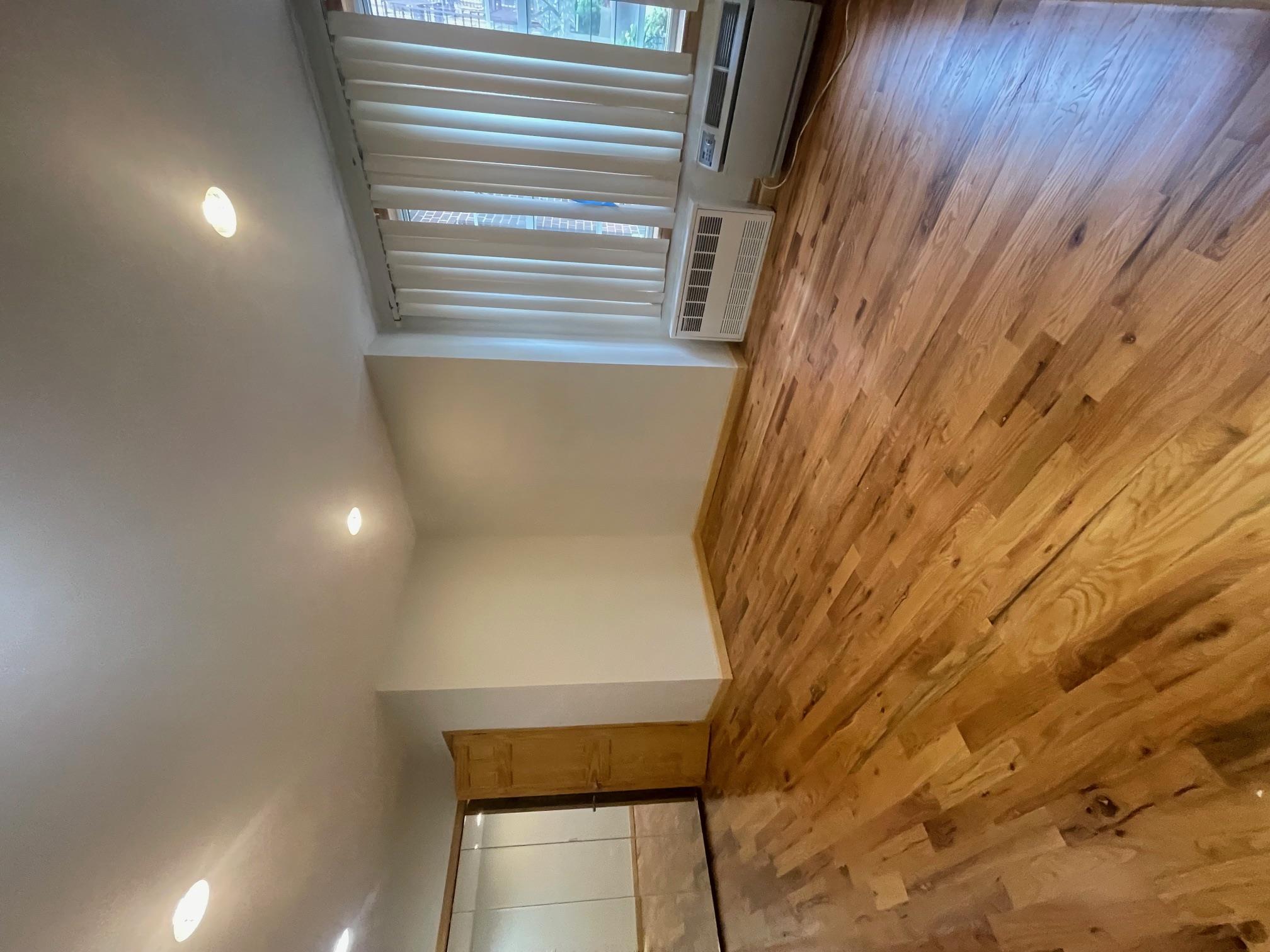 59-30 108th Street, Unit 2JJ Queens, NY 11368 - Photo 6 of 15 Unfurnished room with a wall mounted AC, wood finished floors, and recessed lighting