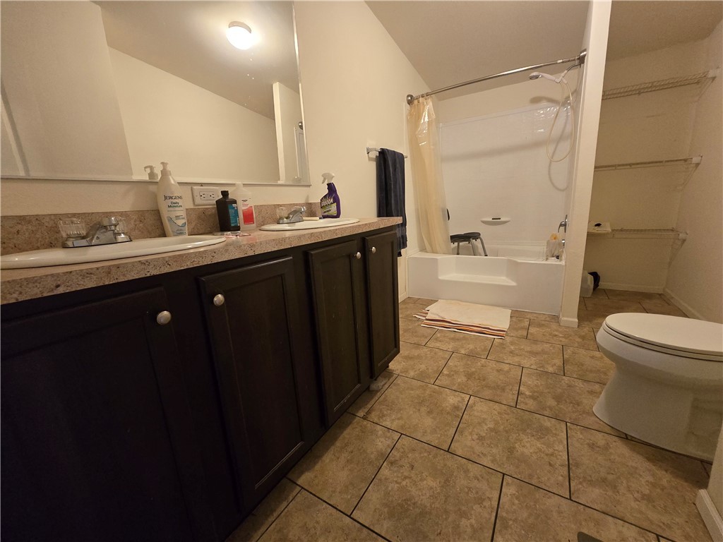 3689 North Avra Road Golden Valley, AZ 86413 - Photo 16 of 32 Bathroom featuring shower / tub combo, double vanity, and light tile patterned floors