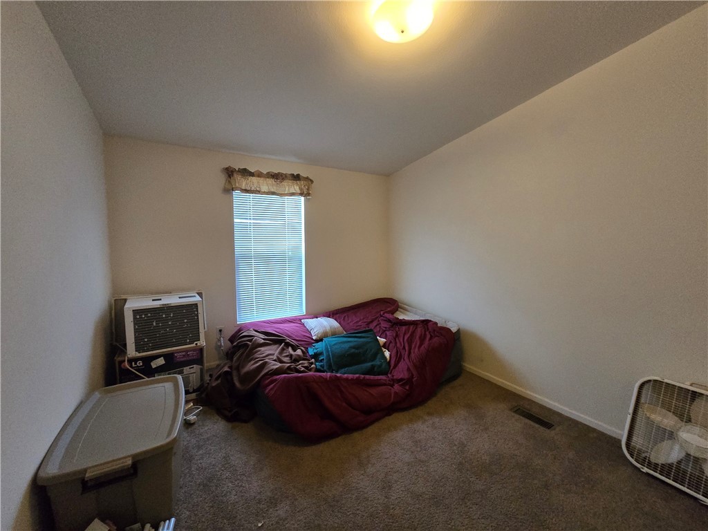 3689 North Avra Road Golden Valley, AZ 86413 - Photo 19 of 32 Carpeted bedroom with baseboards and lofted ceiling