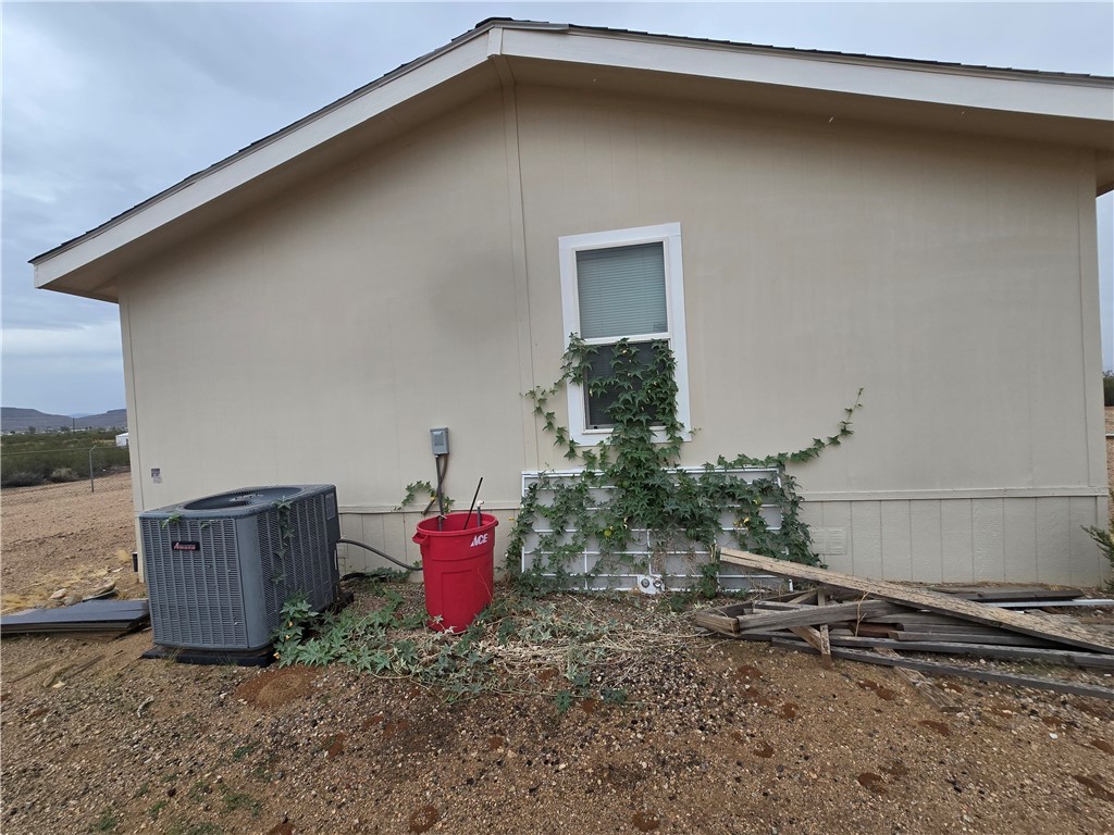 3689 North Avra Road Golden Valley, AZ 86413 - Photo 21 of 32 View of home's exterior with a central air condition unit