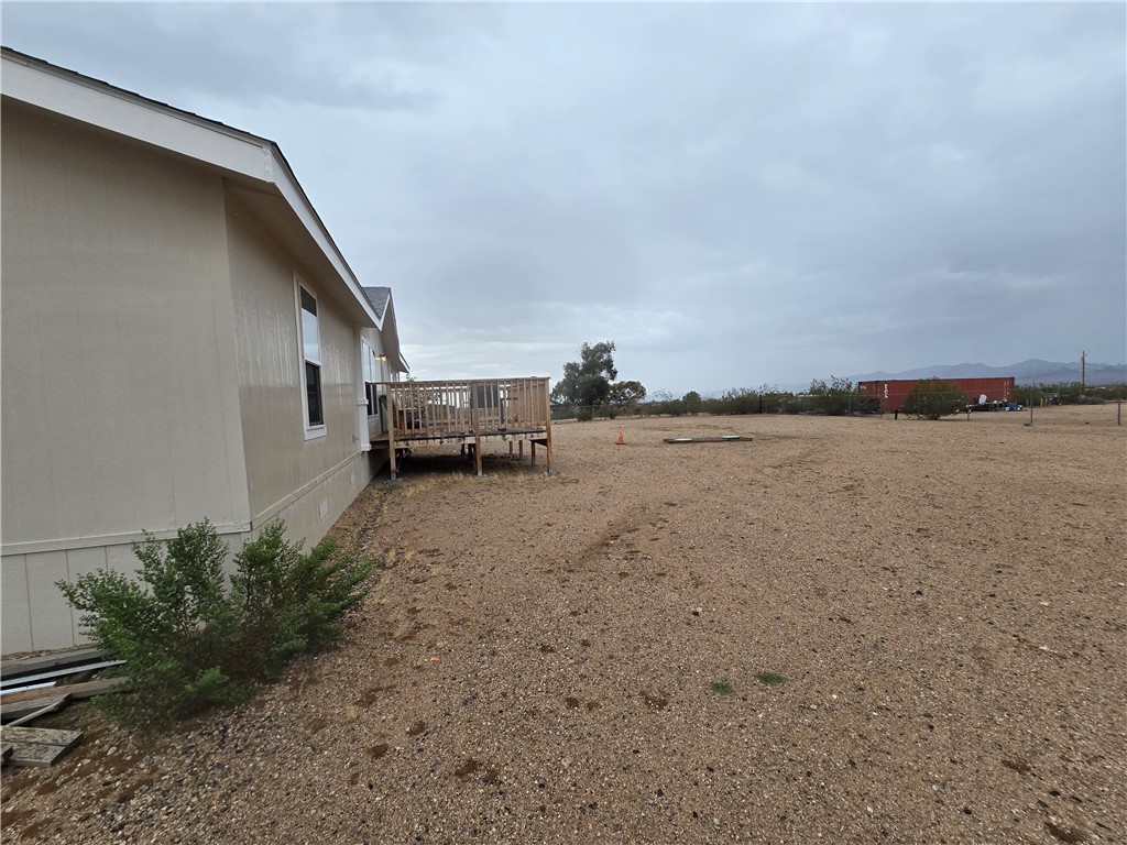 3689 North Avra Road Golden Valley, AZ 86413 - Photo 22 of 32 View of yard with a deck