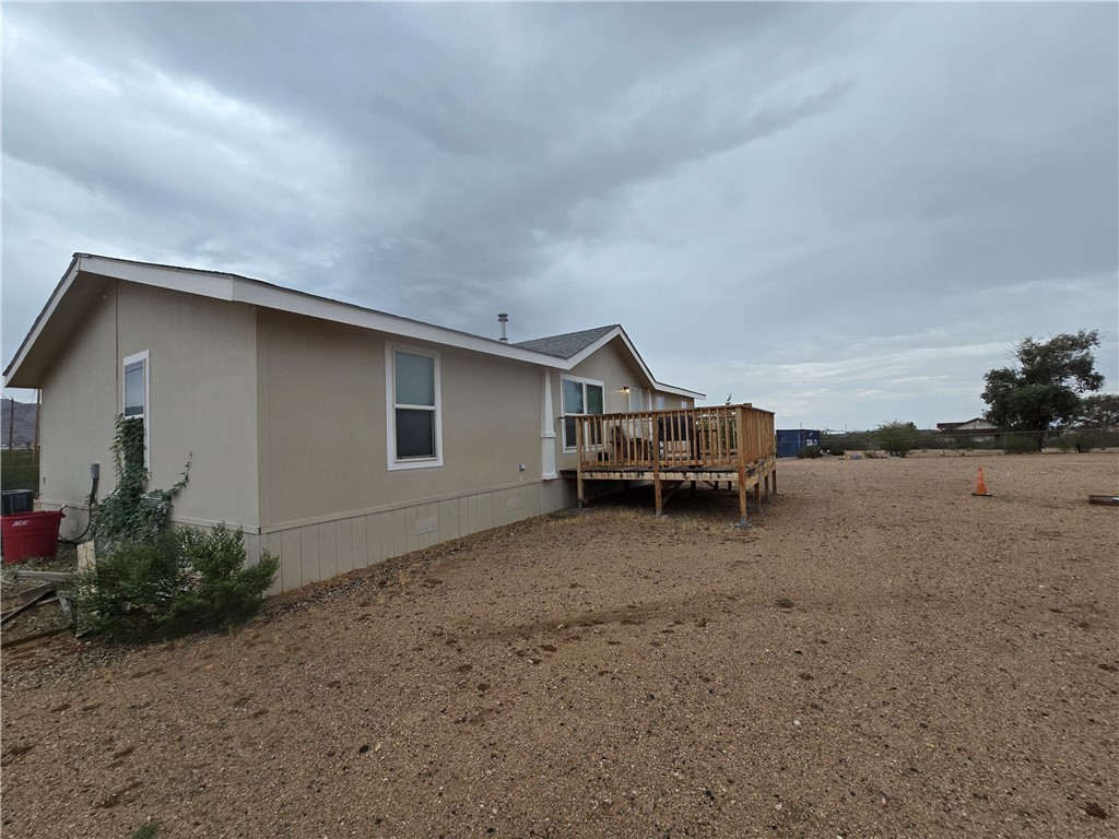 3689 North Avra Road Golden Valley, AZ 86413 - Photo 23 of 32 Rear view of property with a wooden deck