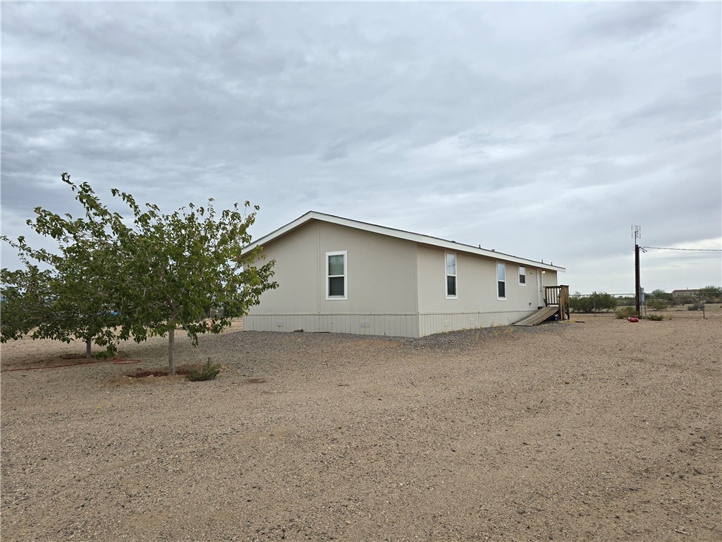 3689 North Avra Road Golden Valley, AZ 86413 - Photo 26 of 32 View of side of property featuring a deck