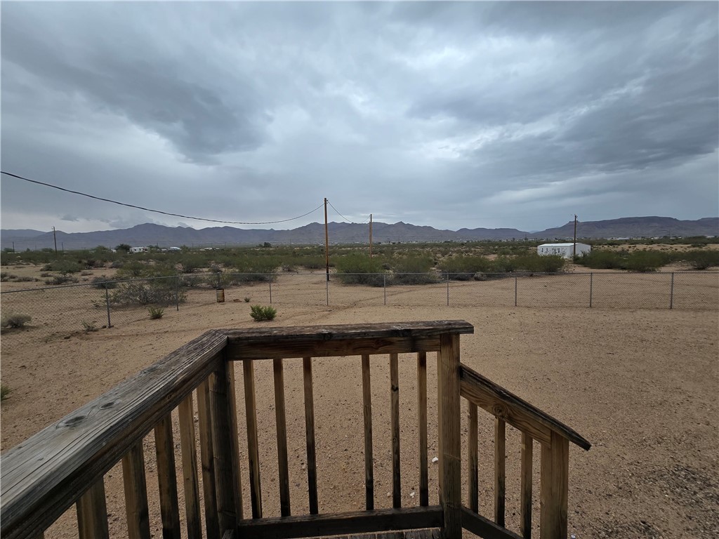3689 North Avra Road Golden Valley, AZ 86413 - Photo 29 of 32 View of yard featuring a view of rural / pastoral area and a deck with mountain view