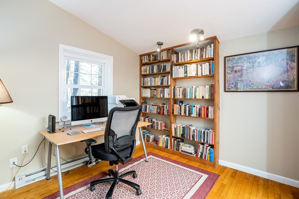 19 Pebble Ridge Road Amherst, MA 01002 - Photo 16 of 42 a view of a workspace with furniture and a book shelf