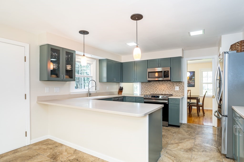 19 Pebble Ridge Road Amherst, MA 01002 - Photo 21 of 42 a kitchen with stainless steel appliances granite countertop a sink a stove and a refrigerator