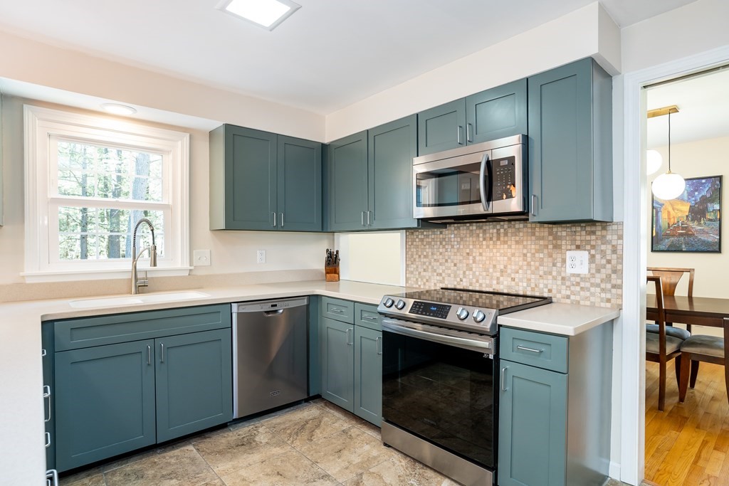 19 Pebble Ridge Road Amherst, MA 01002 - Photo 22 of 42 a kitchen with sink cabinets and microwave