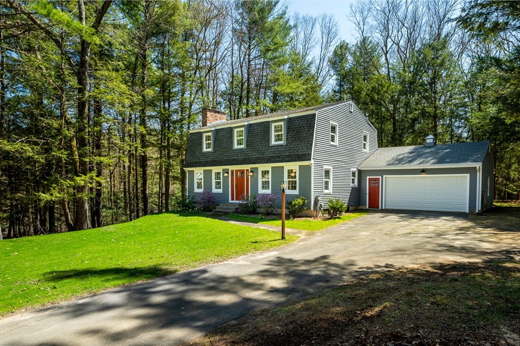 19 Pebble Ridge Road Amherst, MA 01002 - Photo 3 of 42 a front view of a house with a yard and garage