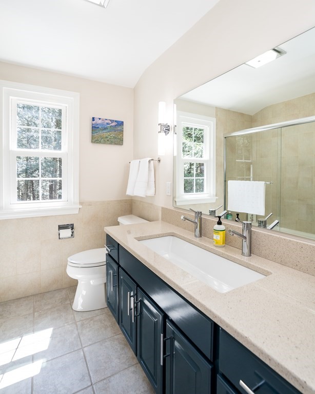 19 Pebble Ridge Road Amherst, MA 01002 - Photo 32 of 42 a bathroom with a granite countertop sink a toilet a mirror and a window
