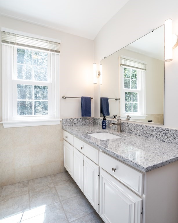 19 Pebble Ridge Road Amherst, MA 01002 - Photo 38 of 42 a bathroom with a granite countertop sink and a window