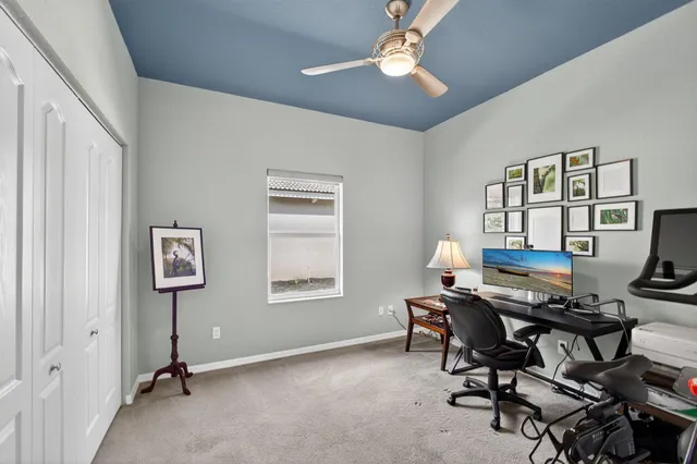 a view of a house with a yard and tree