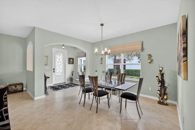 a living room with furniture a fireplace and a chandelier