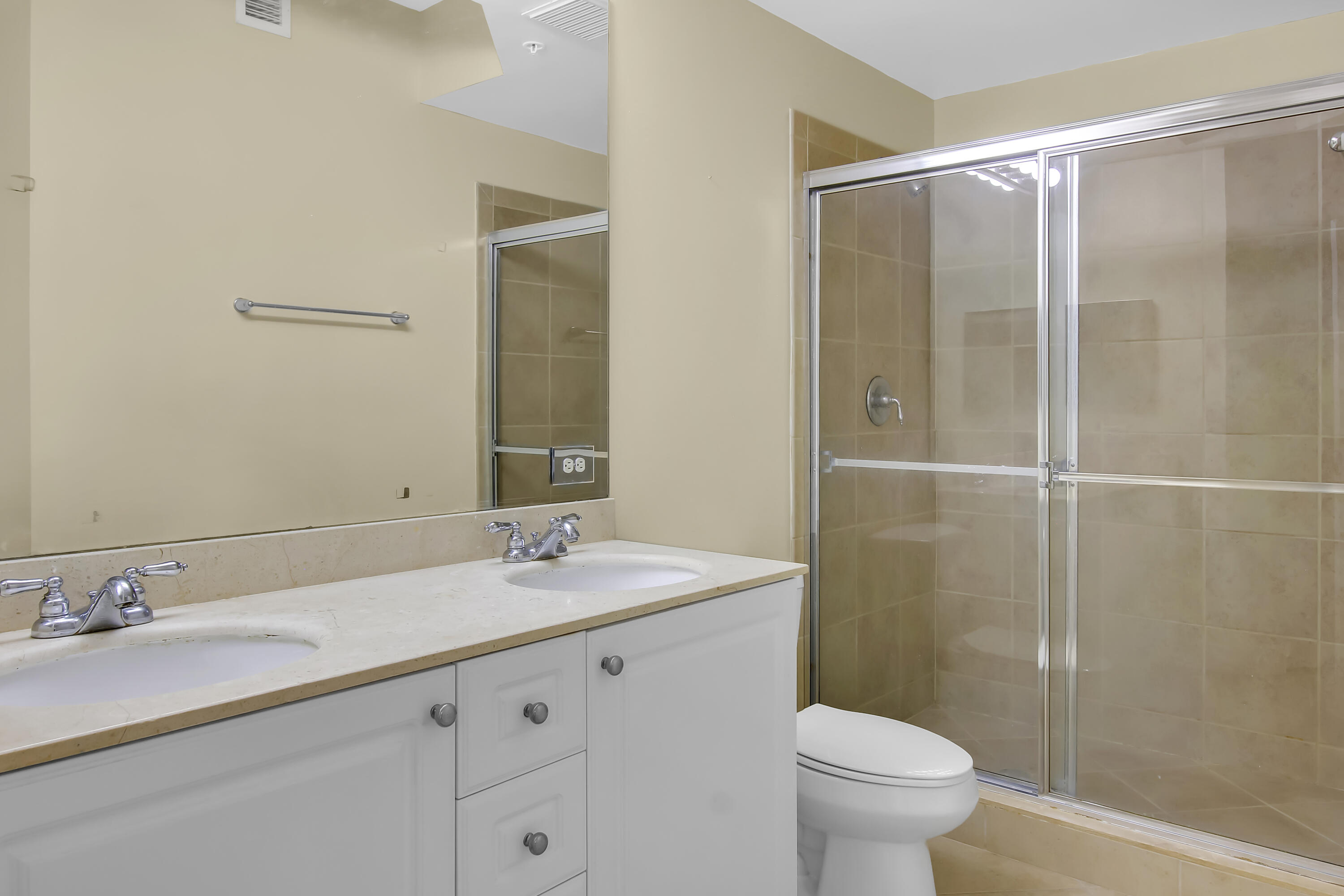 2304 Renaissance Way, Unit 304 Boynton Beach, FL 33426 - Photo 11 of 32 a bathroom with a granite countertop sink toilet and shower
