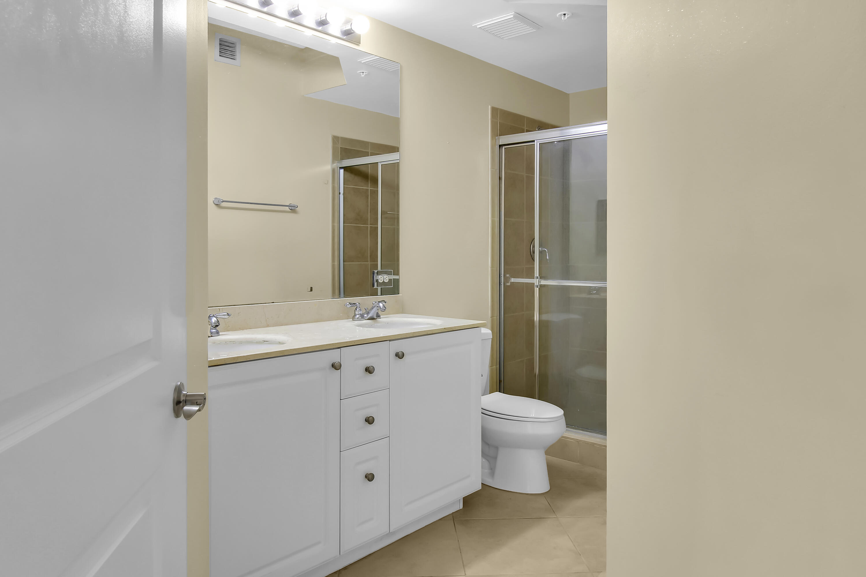 2304 Renaissance Way, Unit 304 Boynton Beach, FL 33426 - Photo 12 of 32 a bathroom with a double vanity sink toilet and a mirror