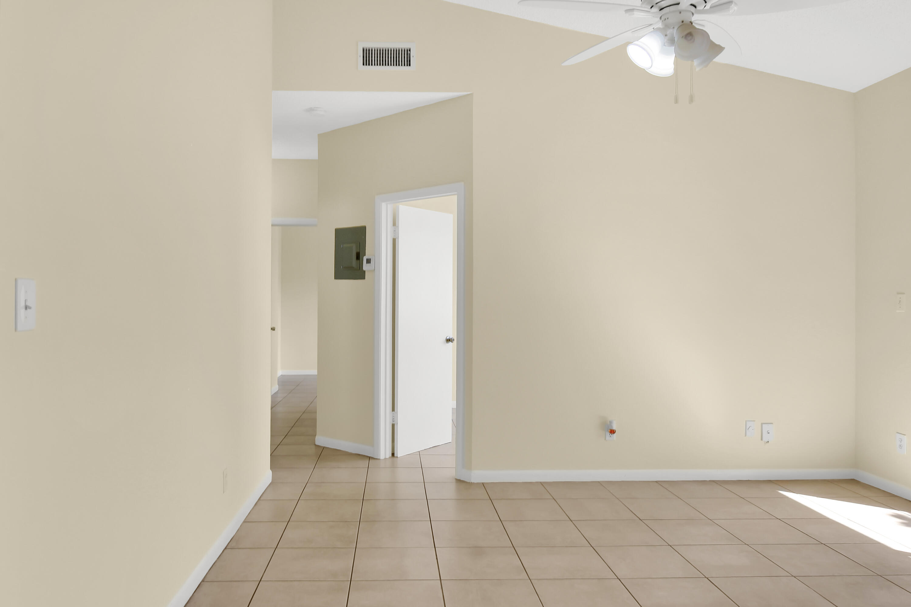 2304 Renaissance Way, Unit 304 Boynton Beach, FL 33426 - Photo 14 of 32 an empty room with a mirror and a fan