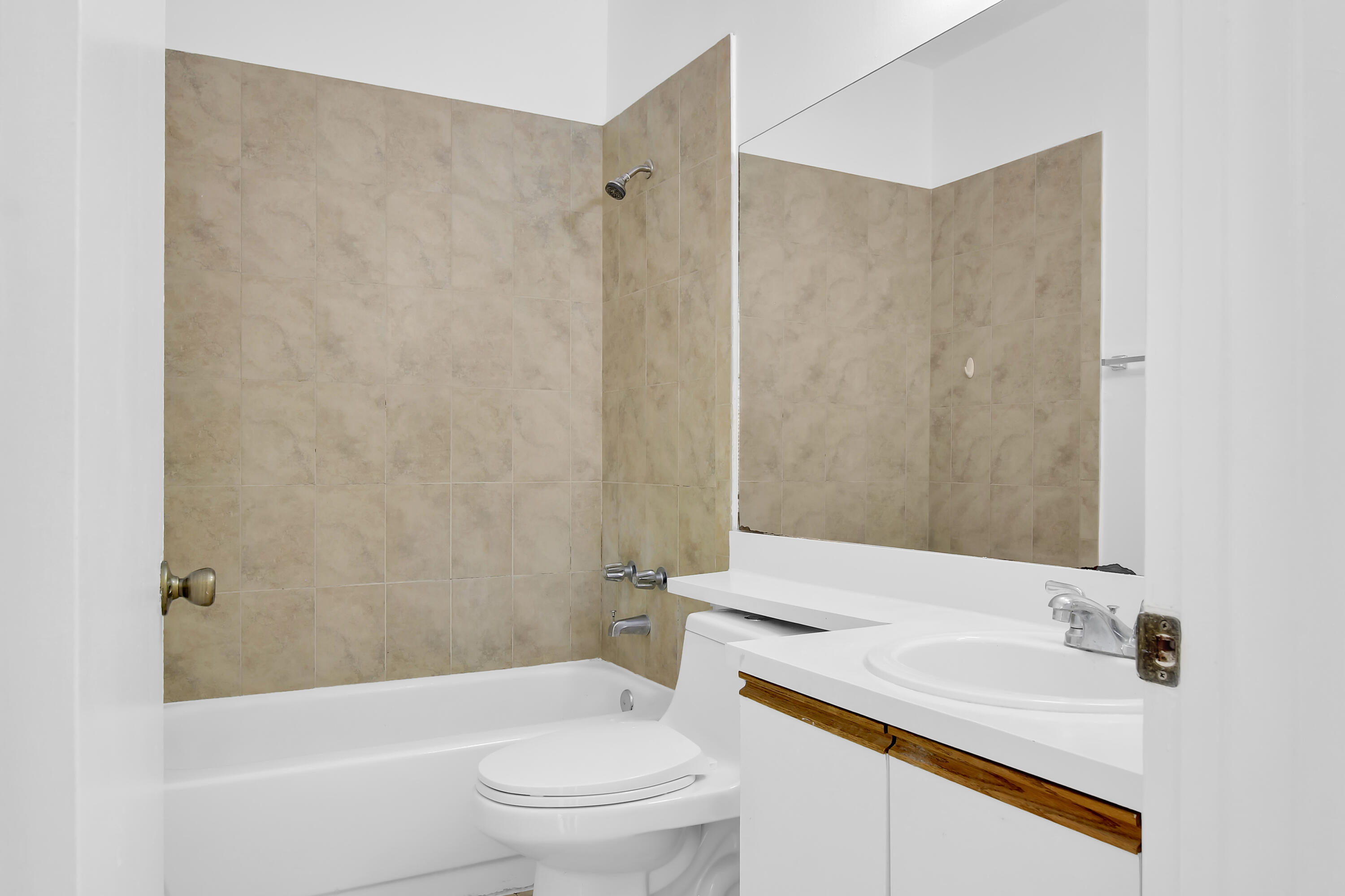 2304 Renaissance Way, Unit 304 Boynton Beach, FL 33426 - Photo 19 of 32 a bathroom with a sink a toilet and shower