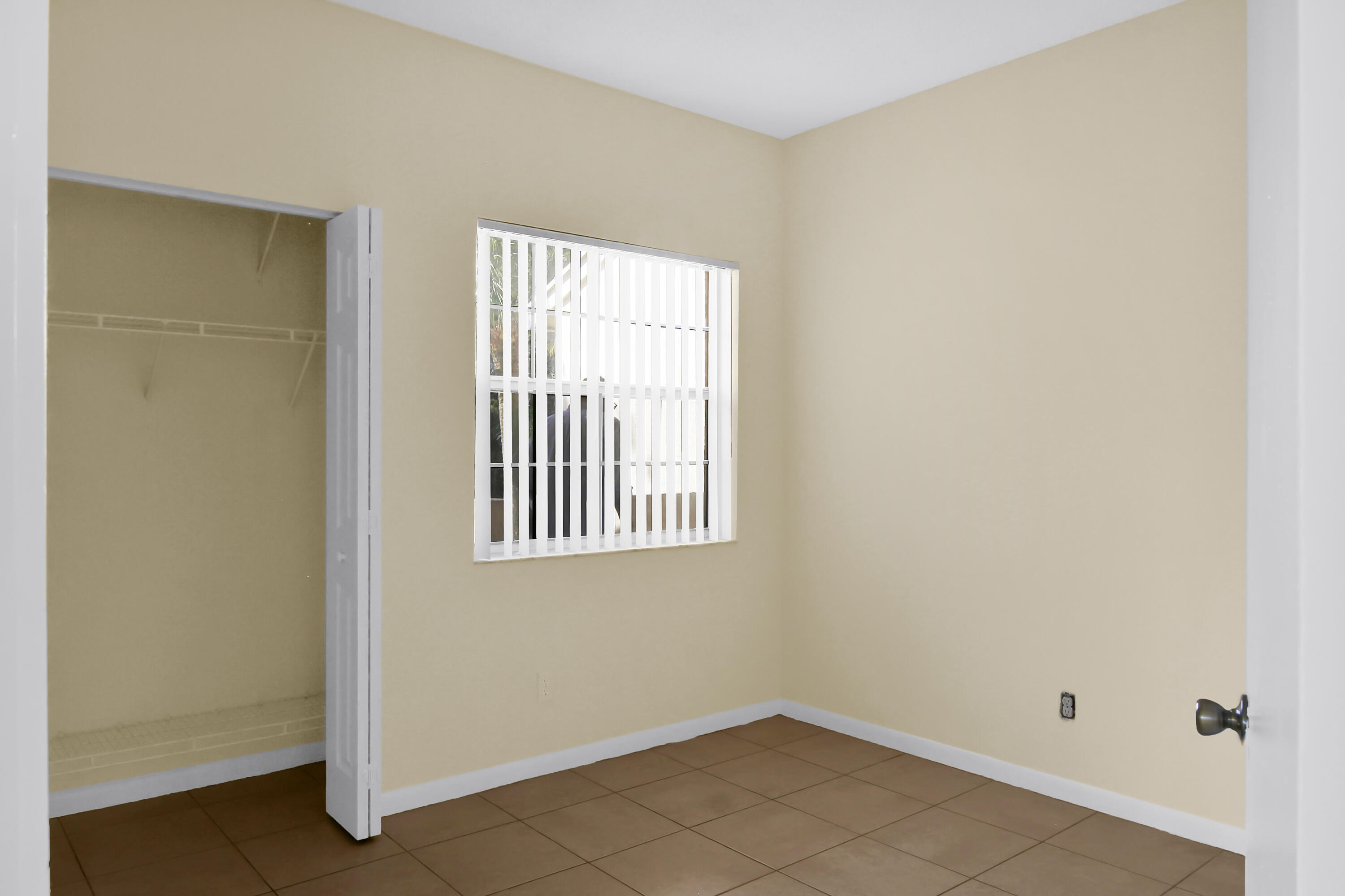 2304 Renaissance Way, Unit 304 Boynton Beach, FL 33426 - Photo 25 of 32 an empty room with a window