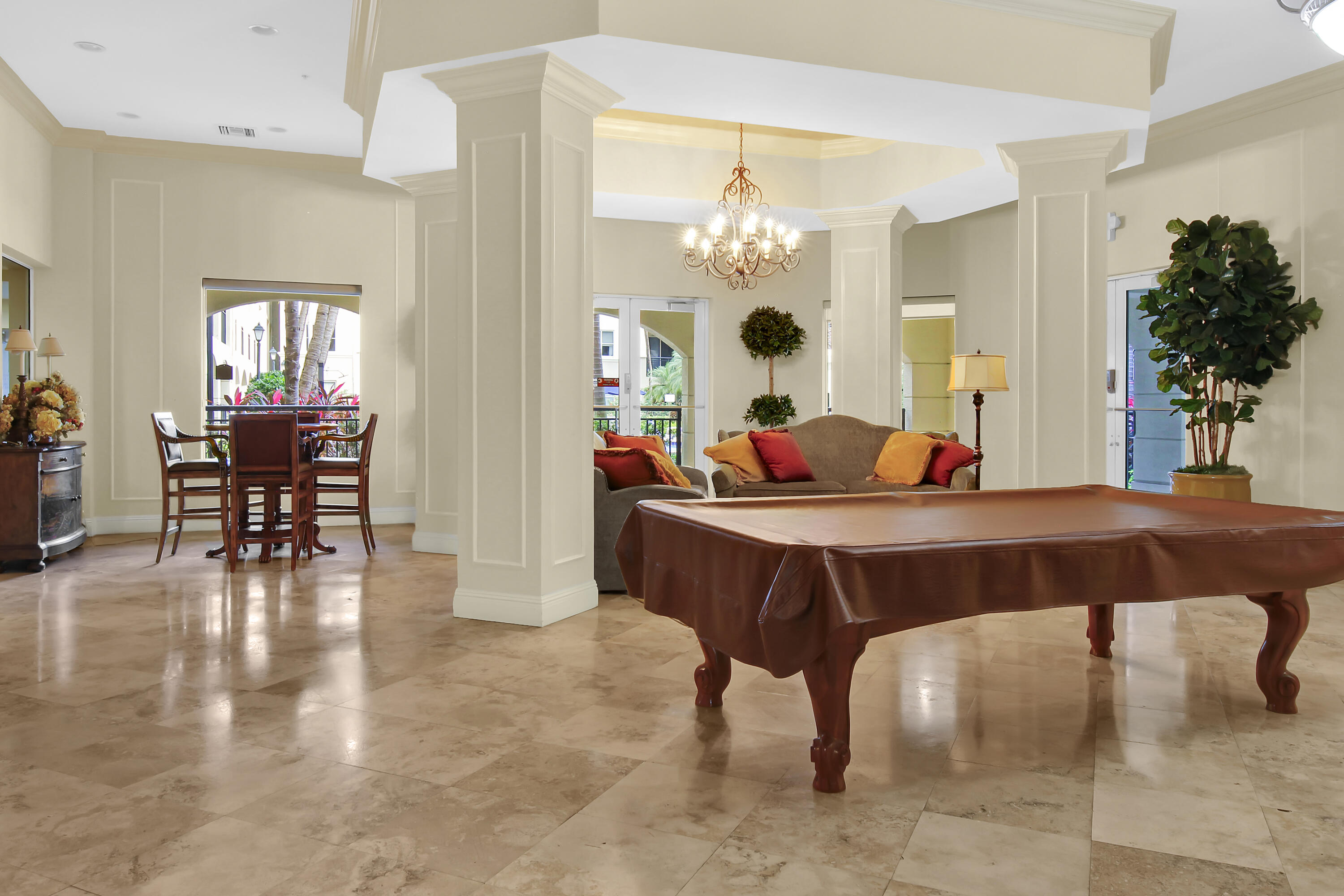 2304 Renaissance Way, Unit 304 Boynton Beach, FL 33426 - Photo 28 of 32 a living room with furniture a chandelier and a chandelier