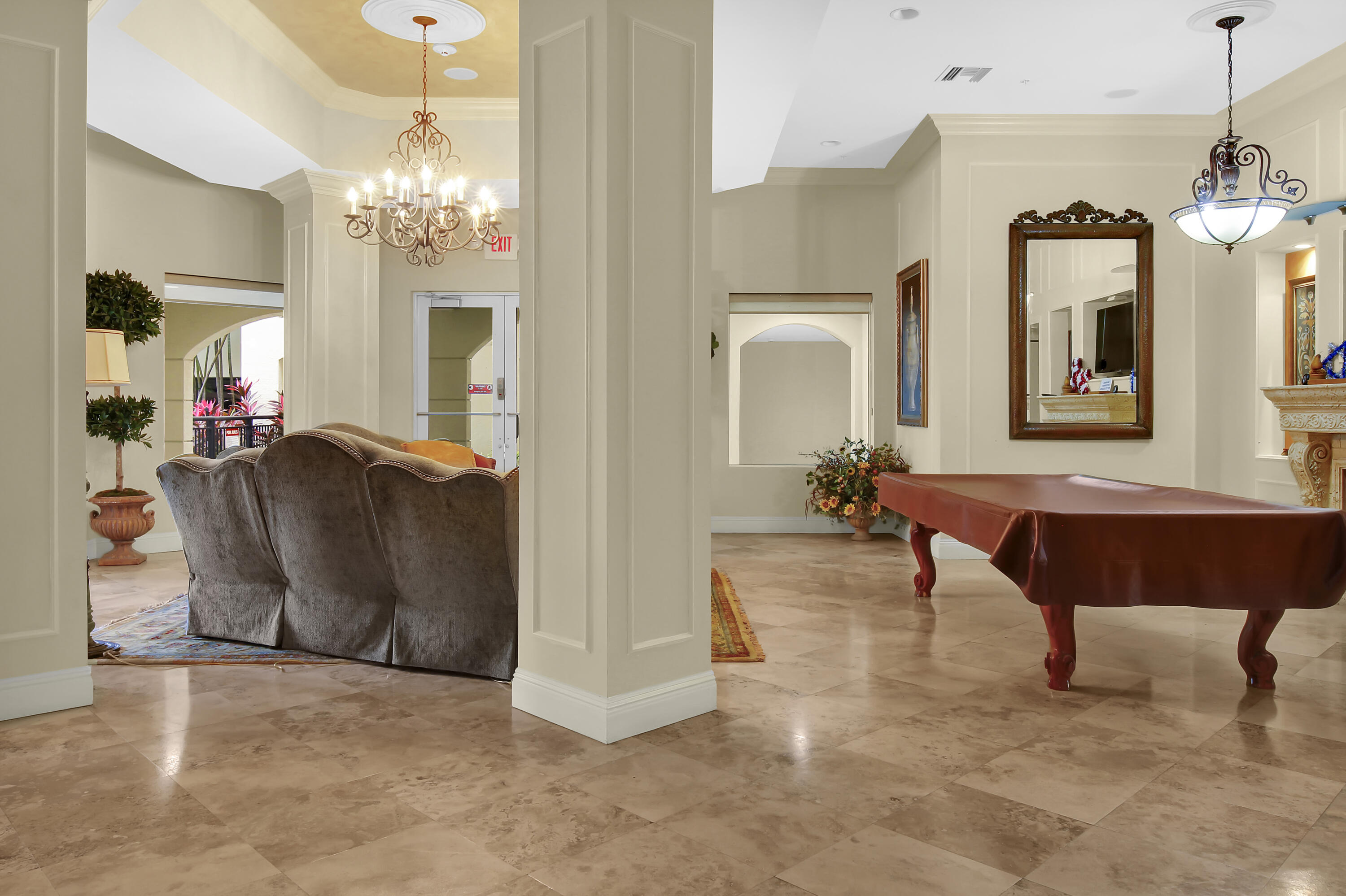 2304 Renaissance Way, Unit 304 Boynton Beach, FL 33426 - Photo 29 of 32 a living room with furniture a chandelier and a mirror