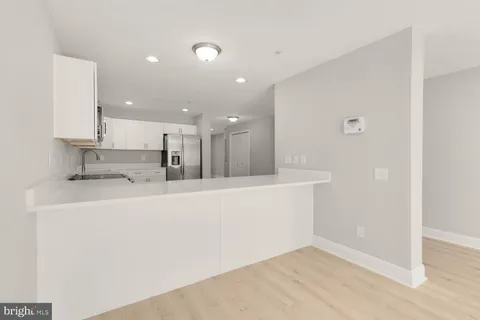 a view of kitchen with kitchen island sink and center island