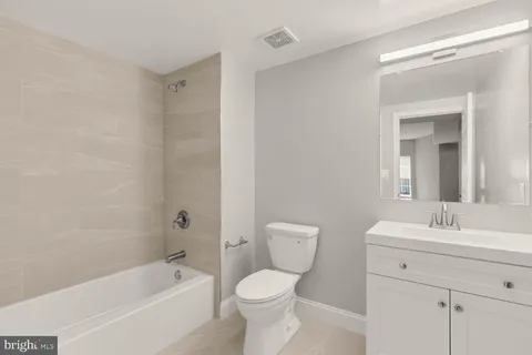 a bathroom with a sink toilet and bathtub