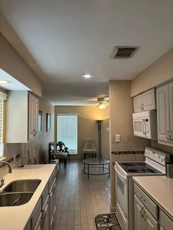 a view of a workspace with furniture and window