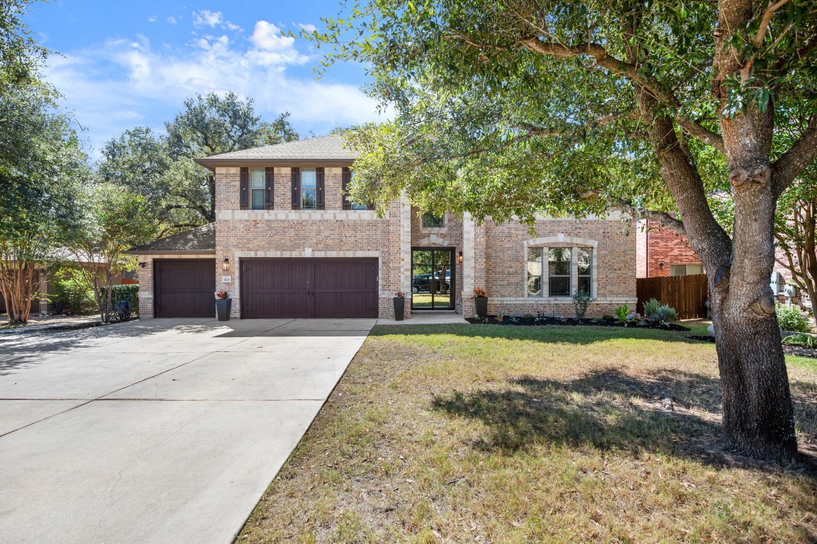 7805 Haggans Lane Austin, TX 78739 - Photo 1 of 1 a front view of a house with a yard and garage