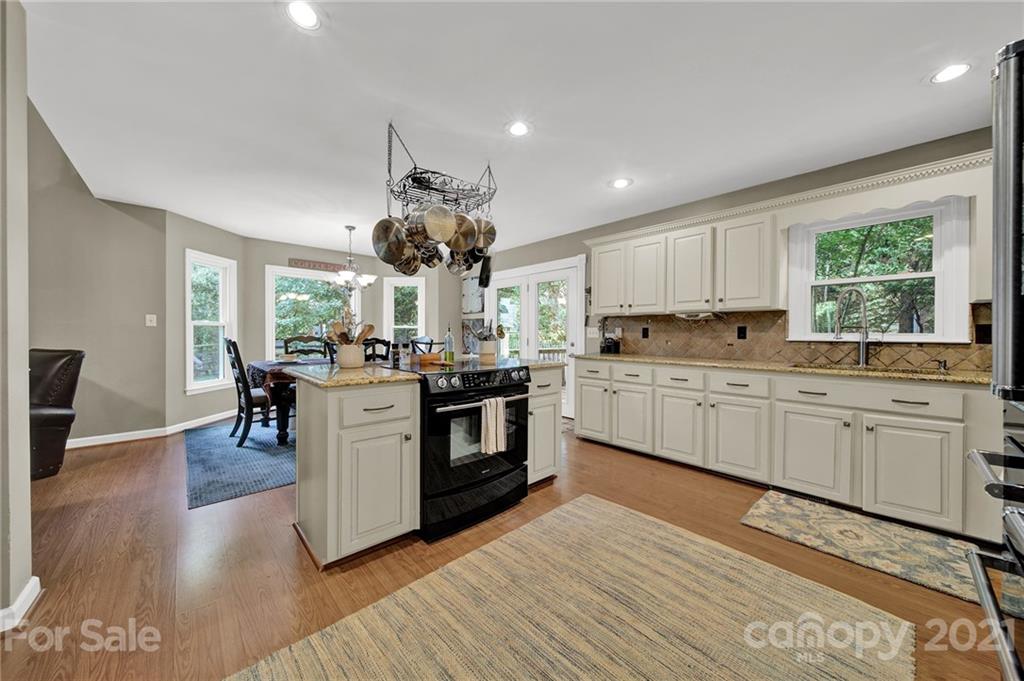 963 Pine Knoll Road Fort Mill, SC 29715 - Photo 8 of 23 a kitchen with a sink cabinets and wooden floor