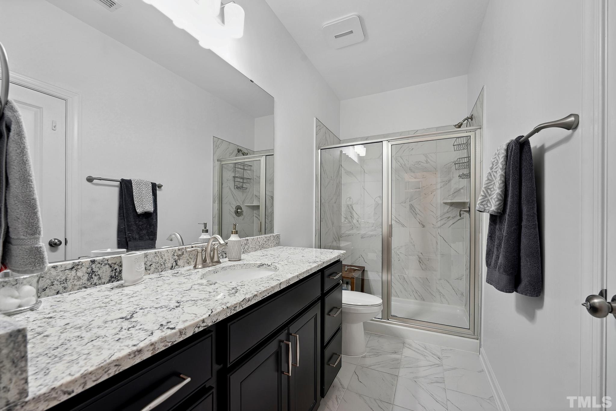 3251 Lynn Road Raleigh, NC 27613 - Photo 8 of 29 a bathroom with a granite countertop sink mirror and shower