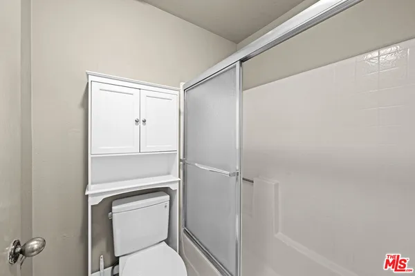 a view of a hallway with wooden floor and windows