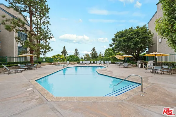 a view of a patio with swimming pool and furniture