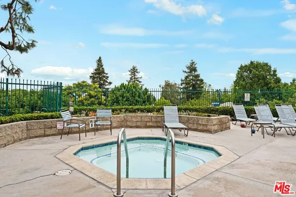 a swimming pool with outdoor seating and yard