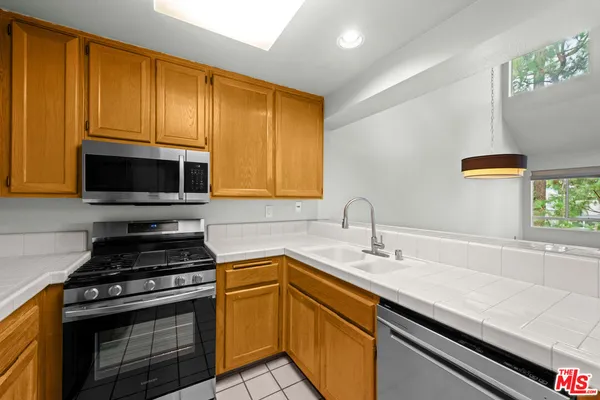 a kitchen with a sink appliances and cabinets