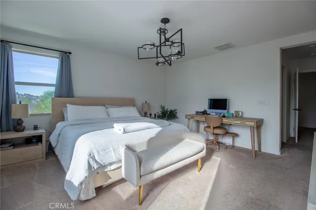 a bedroom with a bed and a table