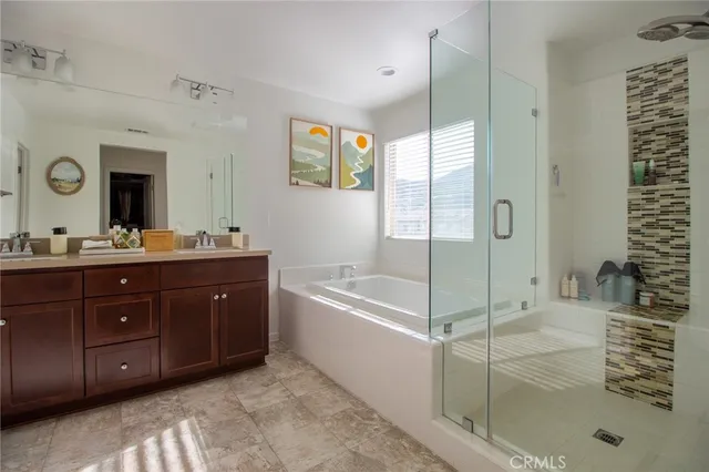 a spacious bathroom with a tub sink and mirror