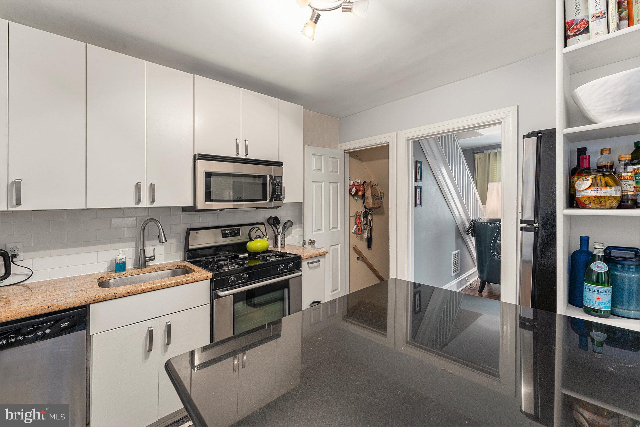 14 Springfield Avenue Flourtown, PA 19031 - Photo 14 of 34 a kitchen with white cabinets a sink and stainless steel appliances