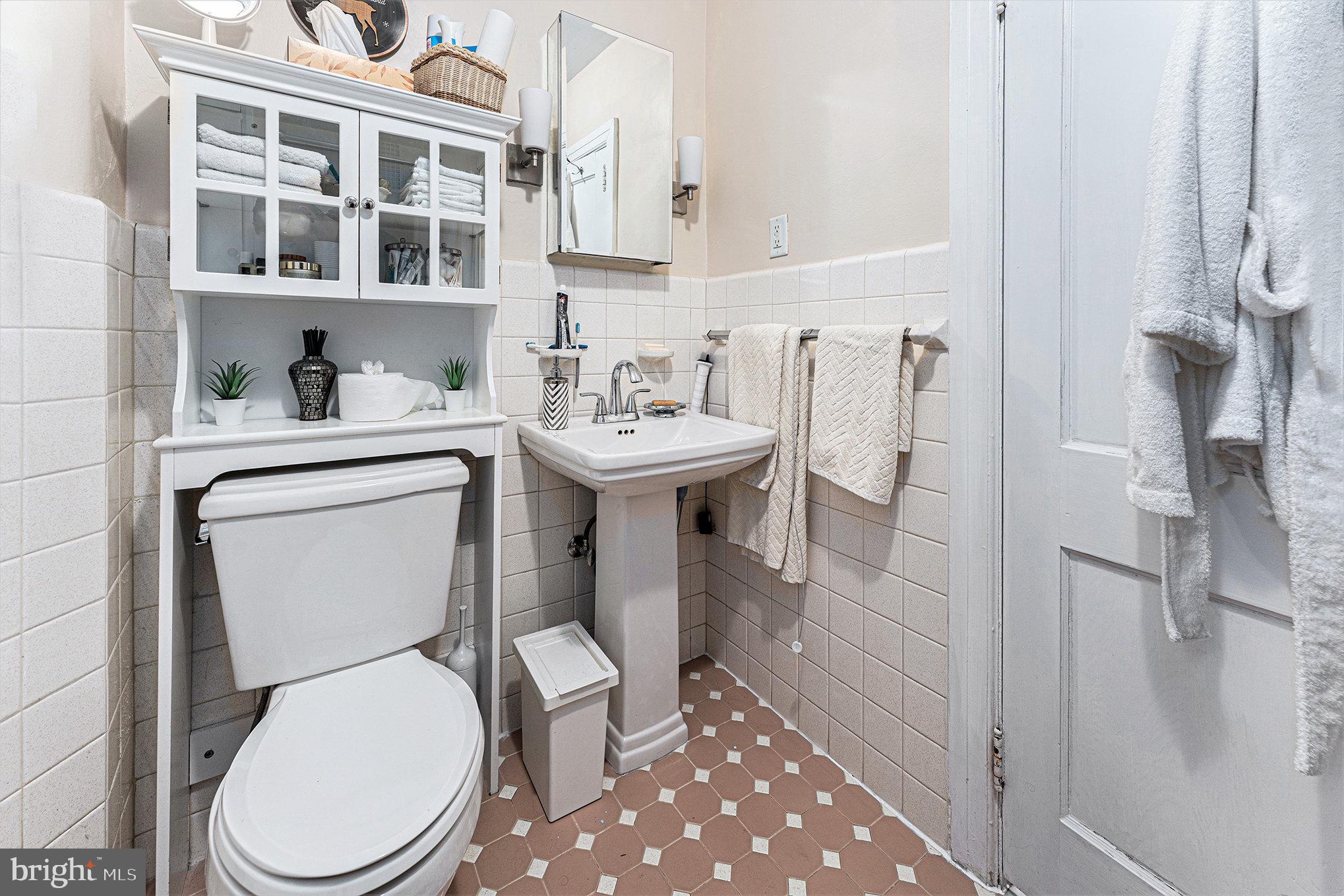 14 Springfield Avenue Flourtown, PA 19031 - Photo 25 of 34 a white toilet sitting next to a bathroom sink