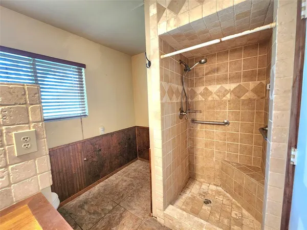 a bathroom with a bathtub and shower