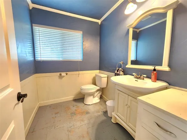 a bathroom with a granite countertop sink toilet a mirror and bathtub